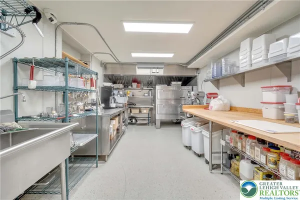 a kitchen with lots of clutter and cabinets