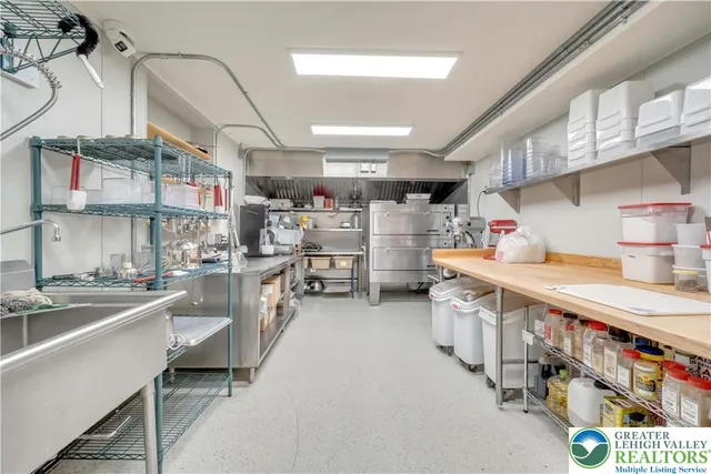 a kitchen with lots of clutter and cabinets