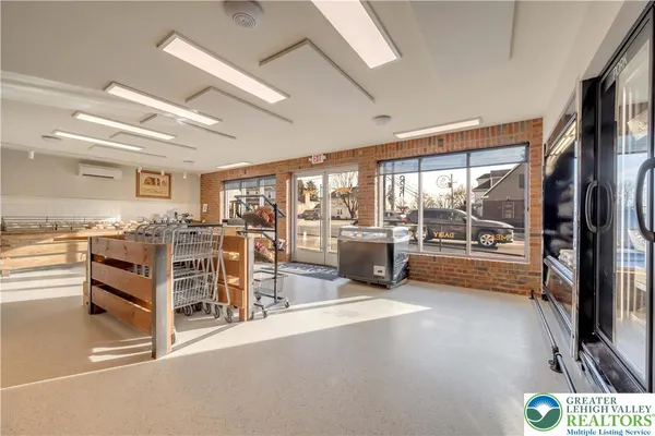 a room with lots of wooden furniture and a large window
