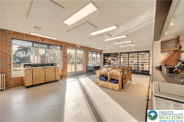 a kitchen with stainless steel appliances kitchen island granite countertop a lot of counter space and a sink