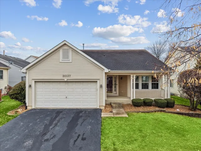 a front view of house with yard and outdoor seating