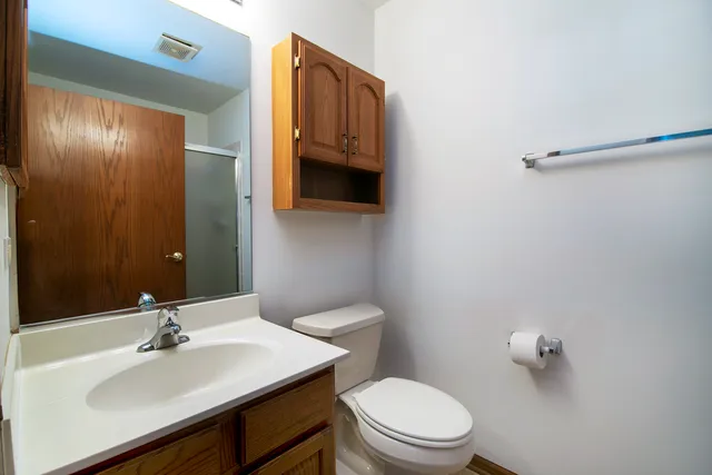 a bathroom with a sink a toilet and mirror