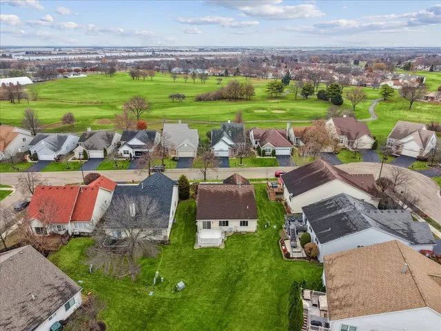 an aerial view of a house with outdoor space swimming pool