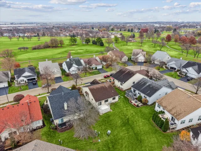 an aerial view of a house with garden space and outdoor seating