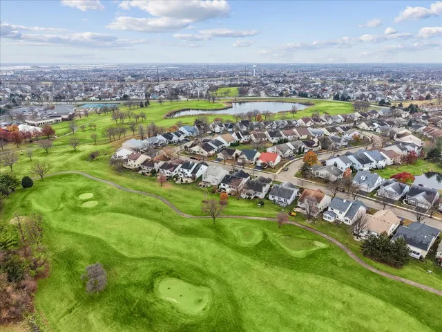 an aerial view of a residential houses with outdoor space and swimming pool