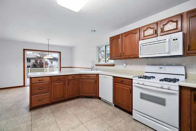a kitchen with stainless steel appliances granite countertop a stove sink and cabinets