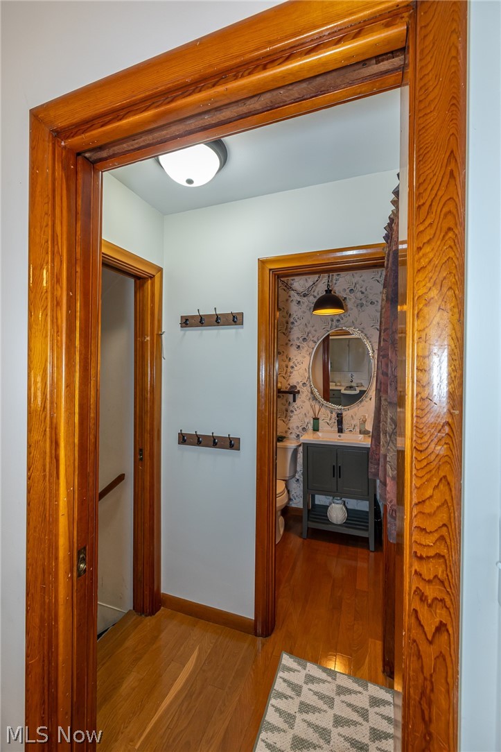 180 South Leavitt Road Amherst, OH 44001 - Photo 15 of 37 Hall with light wood finished floors and baseboards