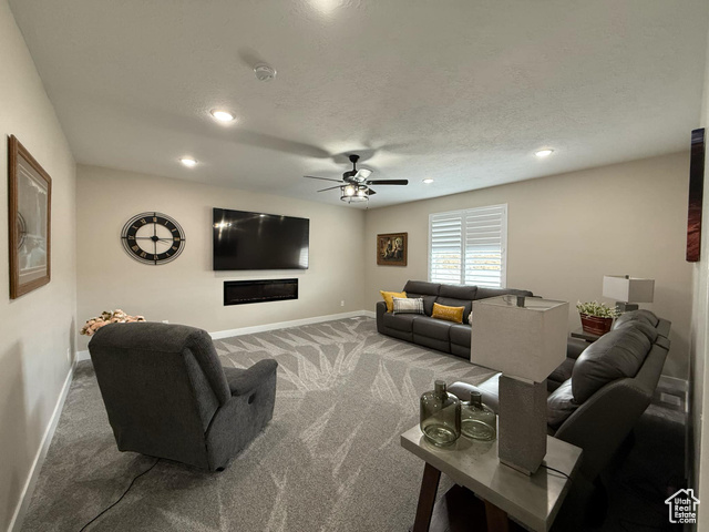 1240 West 2360 North Helper, UT 84526 - Photo 53 of 79 Carpeted living area with baseboards, a textured ceiling, recessed lighting, and a ceiling fan