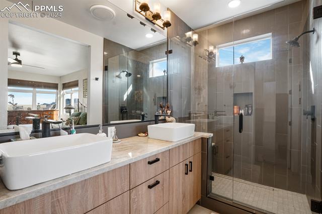 74 Sommerlyn Road Colorado Springs, CO 80906 - Photo 24 of 32 Bathroom featuring a shower with shower door, large vanity, and ceiling fan