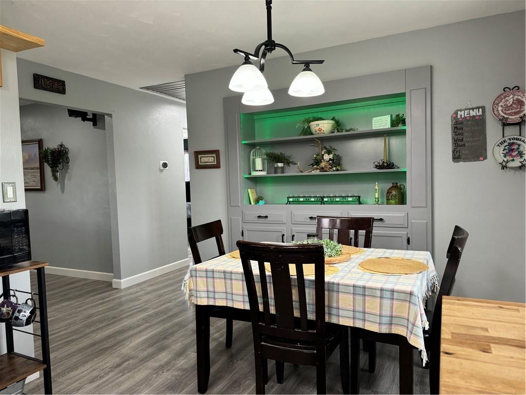 176 Fetsko Road West Middlesex, PA 16159 - Photo 15 of 34 a dining room with wooden floor a chandelier a wooden table and chairs