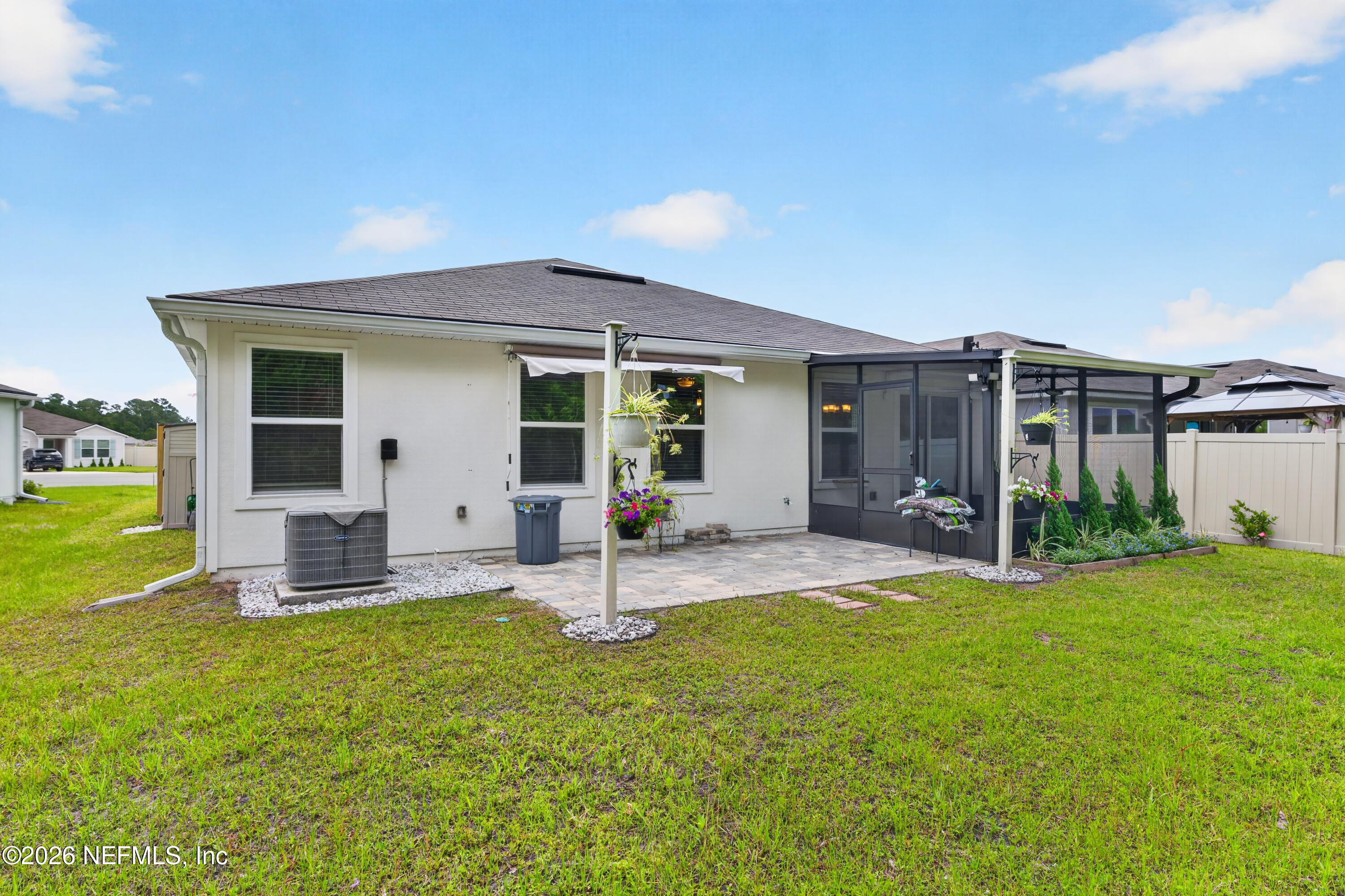 231 Encanto Way Street St. Augustine, FL 32084 - Photo 20 of 36 a front view of a house with patio and garden