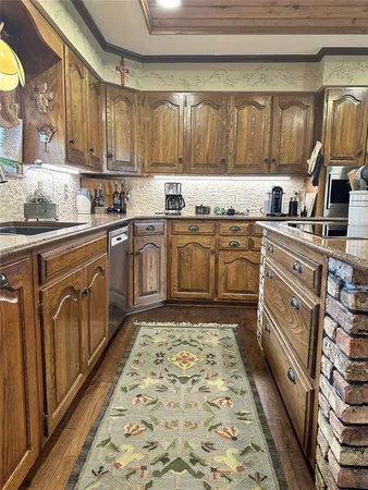 a kitchen with stainless steel appliances granite countertop a sink and cabinets
