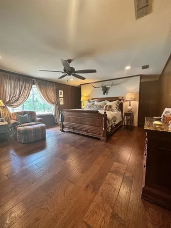 a bedroom with furniture and a window