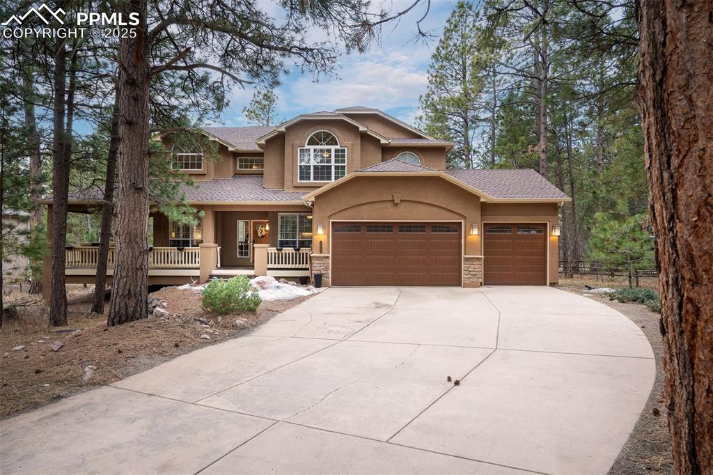 15580 Deercross Court Colorado Springs, CO 80921 - Photo 1 of 50 a front view of a house with garden
