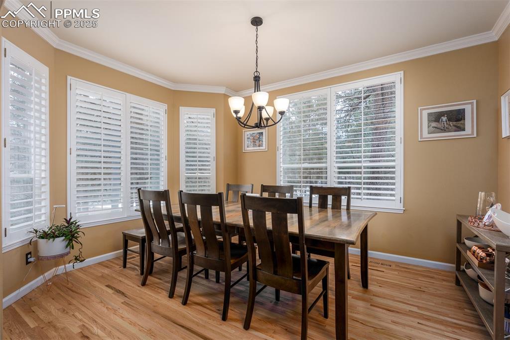 15580 Deercross Court Colorado Springs, CO 80921 - Photo 24 of 50 a view of a dining room with furniture window and wooden floor