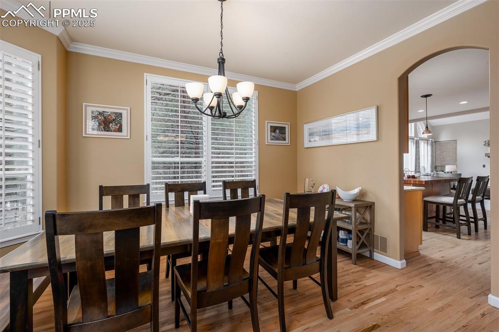 15580 Deercross Court Colorado Springs, CO 80921 - Photo 25 of 50 a view of a dining room with furniture wooden floor and chandelier