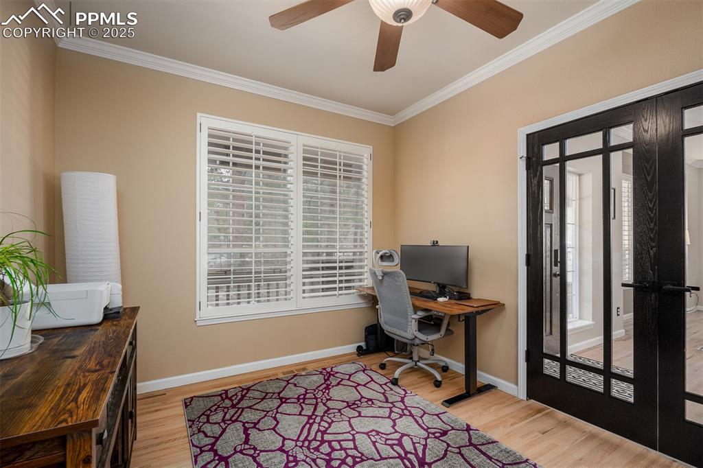 15580 Deercross Court Colorado Springs, CO 80921 - Photo 27 of 50 a view of a workspace with furniture and a window