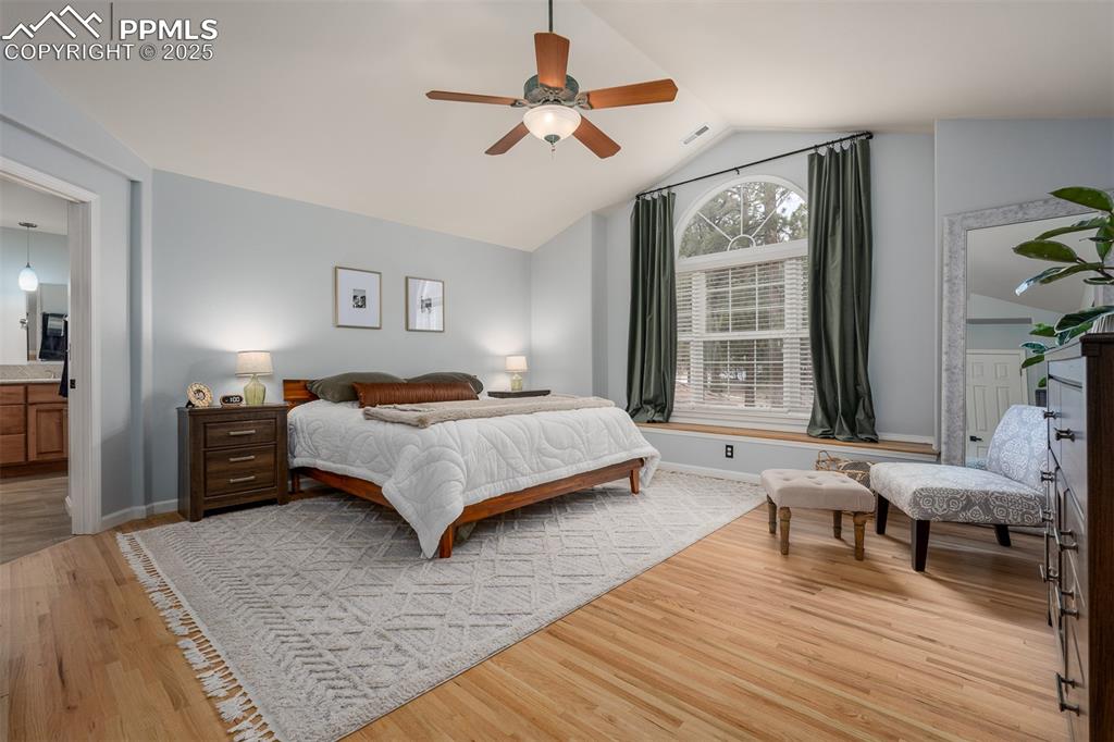 15580 Deercross Court Colorado Springs, CO 80921 - Photo 29 of 50 a bedroom with a bed and wooden floor