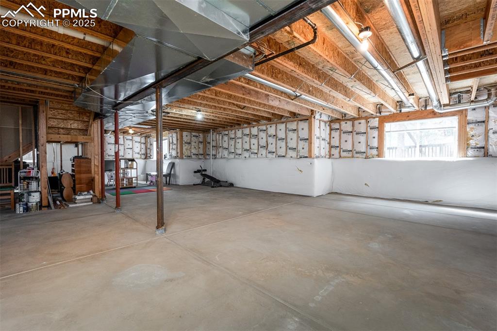 15580 Deercross Court Colorado Springs, CO 80921 - Photo 42 of 50 a view of empty room with wooden ceiling