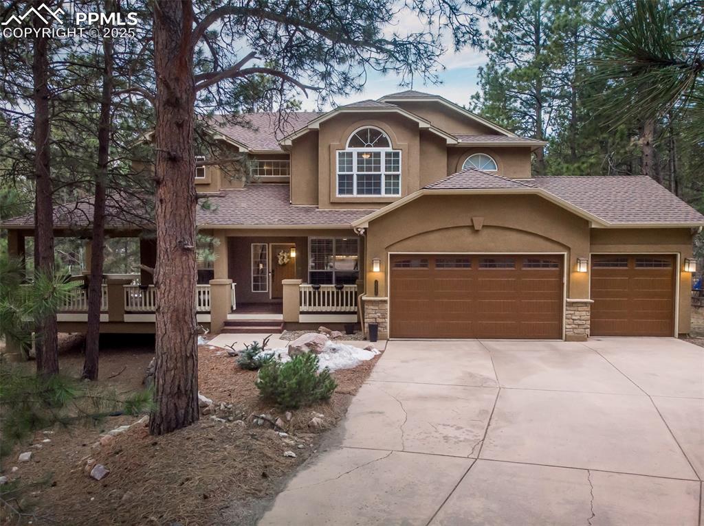 15580 Deercross Court Colorado Springs, CO 80921 - Photo 50 of 50 a front view of a house with a yard and garage