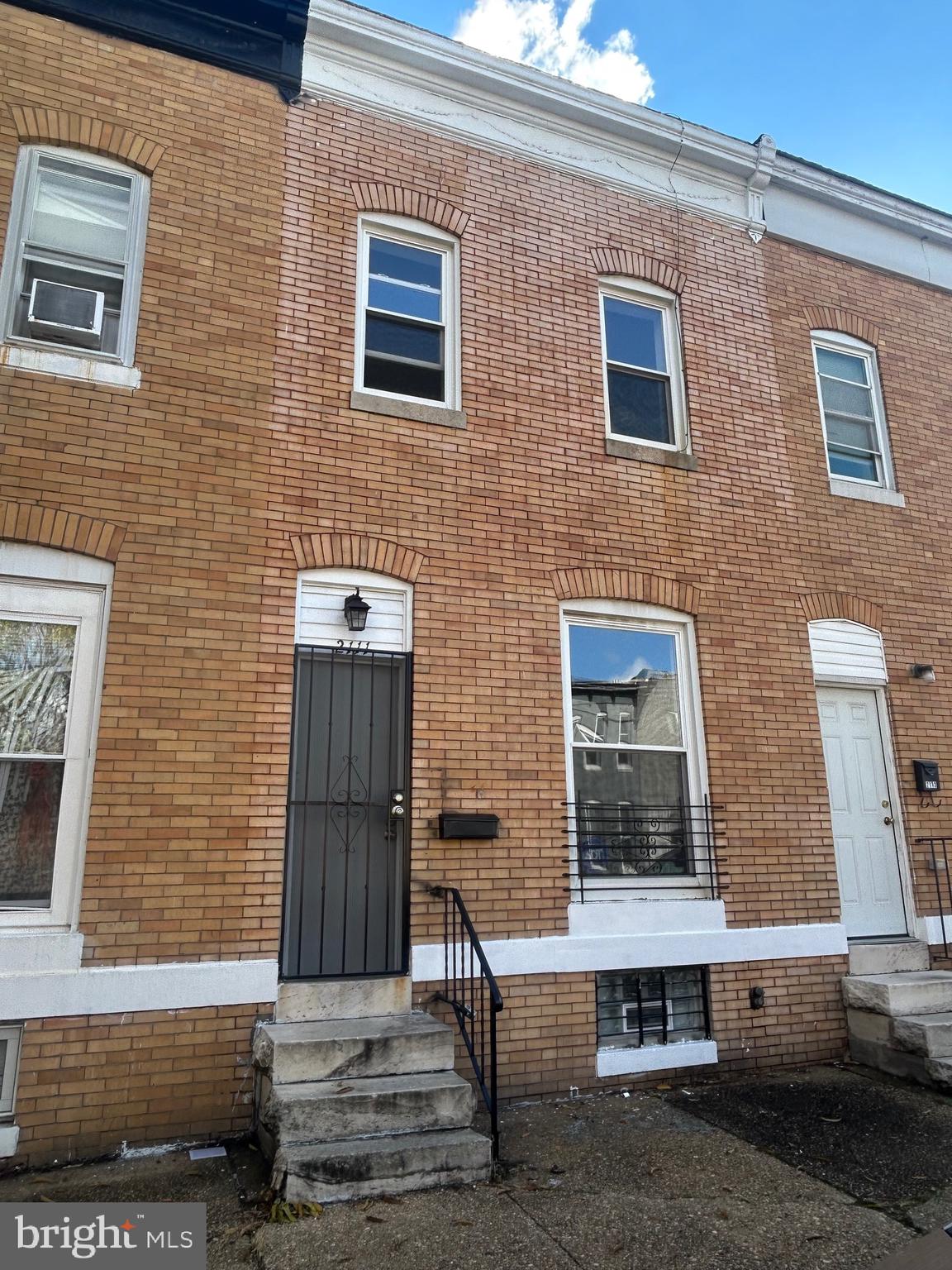 a brick house with four windows