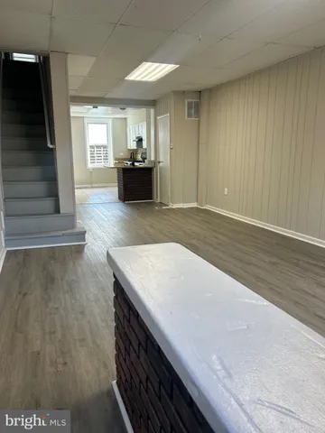 a view of kitchen and hall with wooden floor