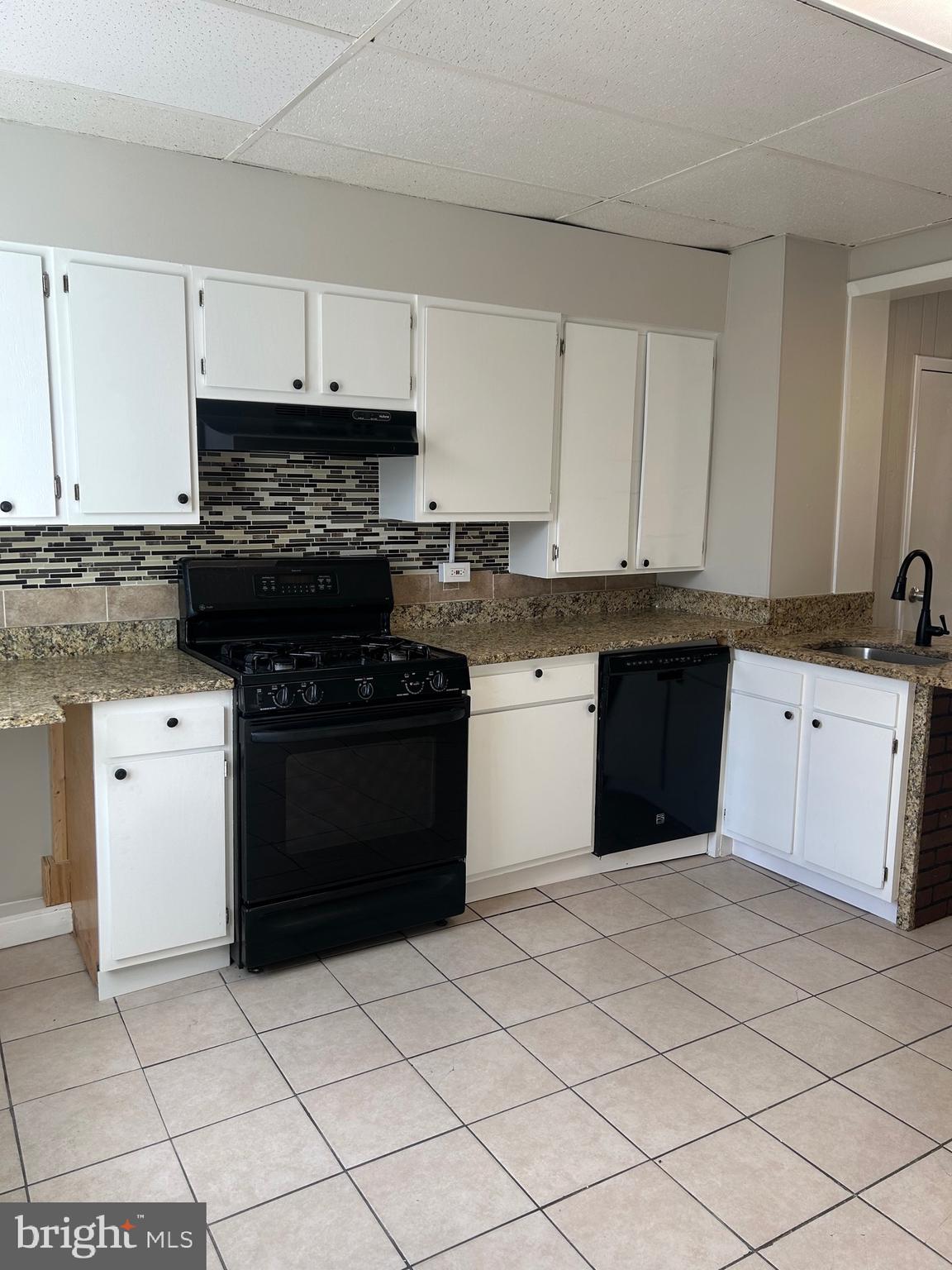 2111 Eagle Street Baltimore, MD 21223 - Photo 4 of 16 a kitchen with a sink a stove and cabinets