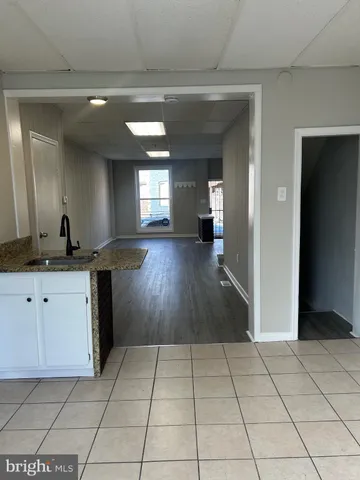 a view of entryway with kitchen and sink