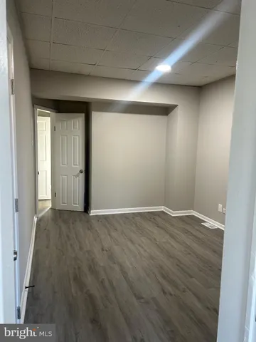 an empty room with wooden floor