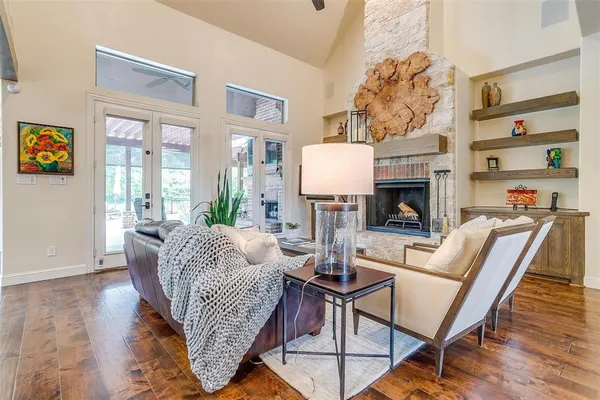 a living room with furniture fireplace and a large window