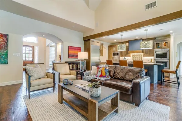 a living room with furniture kitchen view and a table