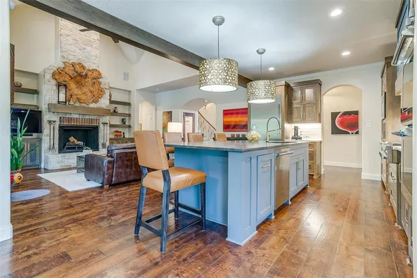 a living room with furniture a fireplace and a chandelier