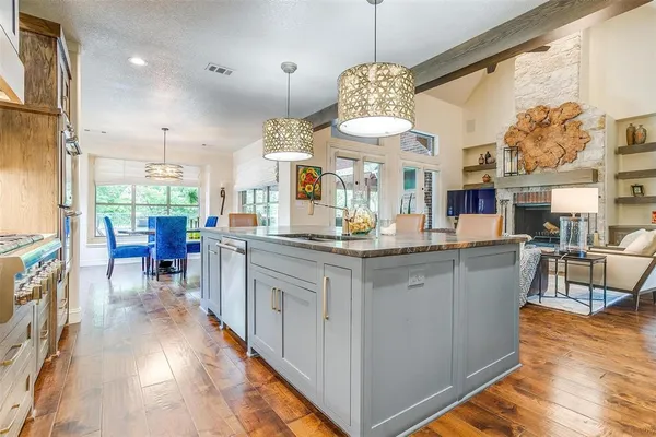 a open kitchen with stainless steel appliances granite countertop a stove and refrigerator