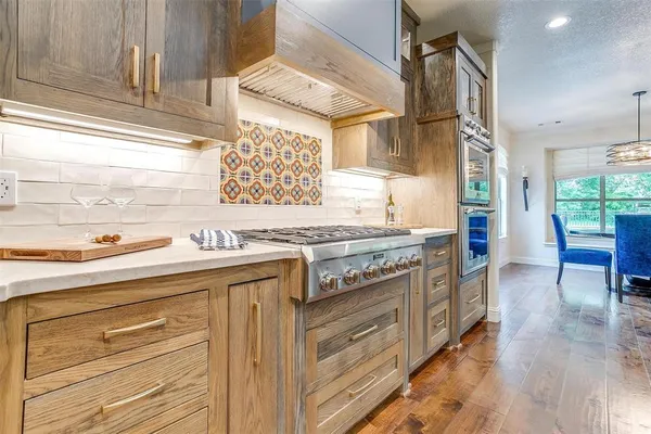 a kitchen with stainless steel appliances granite countertop a stove and a sink