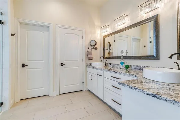 a spacious bathroom with a granite countertop sink mirror and double