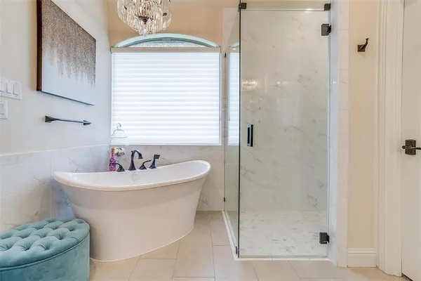 a white bath tub sitting next to a white sink