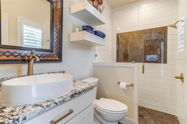 a bathroom with a tub sink and mirror