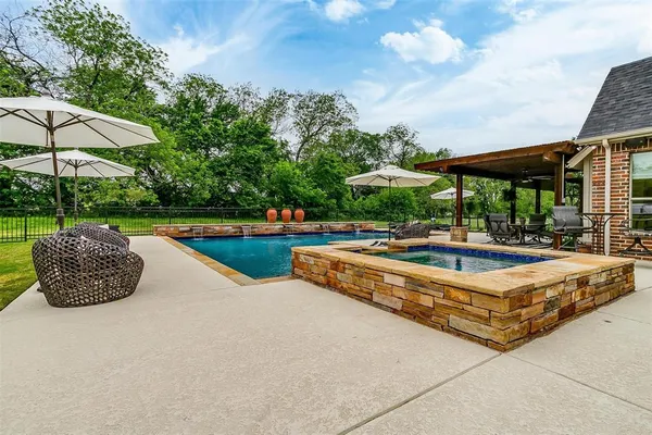 a swimming pool with outdoor seating yard and outdoor seating