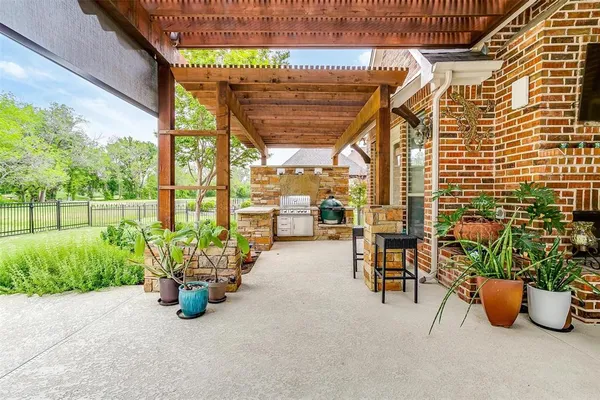 a view of a patio with chairs and potted plants