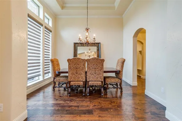 a dining room with furniture and wooden floor