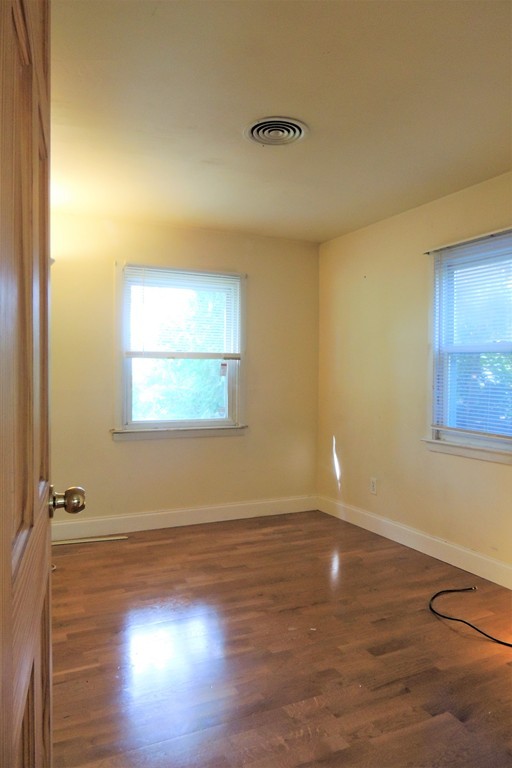 20 Keddy Street Springfield, MA 01109 - Photo 12 of 17 an empty room with wooden floor and windows