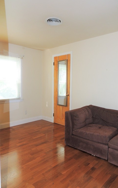20 Keddy Street Springfield, MA 01109 - Photo 13 of 17 a living room with couch and a wooden floor