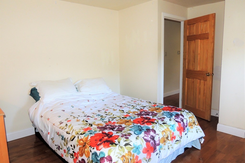 20 Keddy Street Springfield, MA 01109 - Photo 16 of 17 a bedroom with a bed and wooden floor