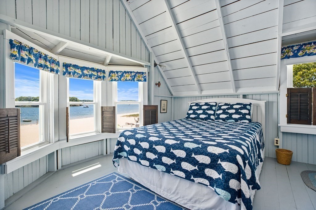 7 Pequod Lane Wareham, MA 02532 - Photo 16 of 26 a large bed sitting in a bedroom next to a window