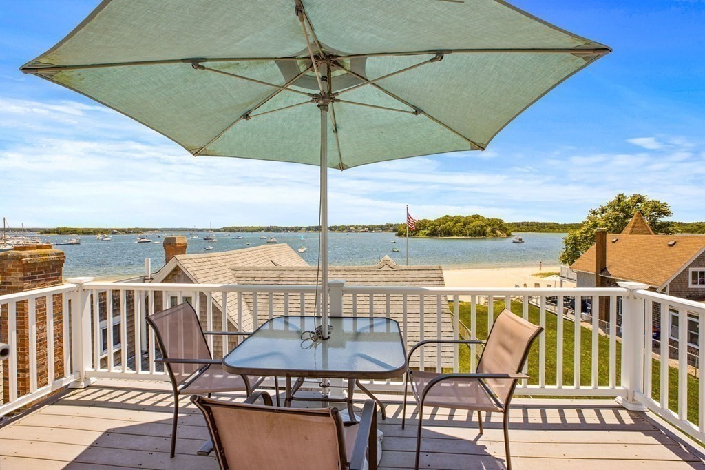 7 Pequod Lane Wareham, MA 02532 - Photo 23 of 26 a view of a balcony with table and chairs under an umbrella
