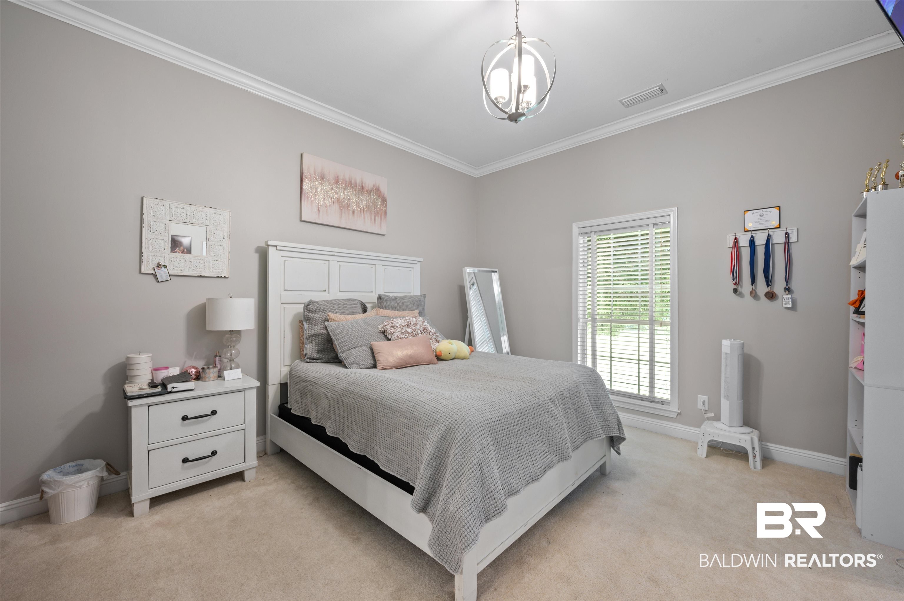 141 Blue Ridge Drive Monroeville, AL 36460 - Photo 17 of 40 Bedroom with ornamental molding, light colored carpet, and a chandelier