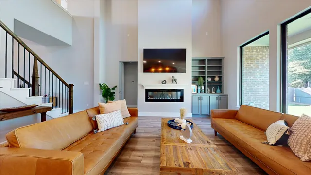a living room with furniture flat screen tv and a fireplace