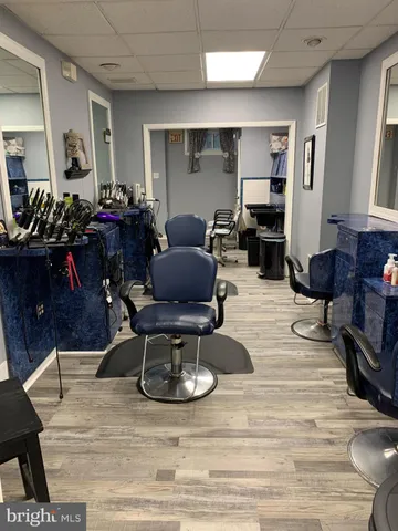 a living room with lots of furniture and gym equipment