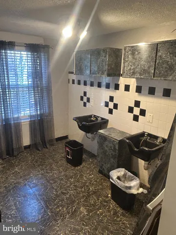 a kitchen with a sink and a stove top oven