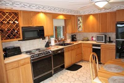 360 Lower County Road Harwich Port, MA 02646 - Photo 9 of 33 a kitchen with a sink a stove and a microwave